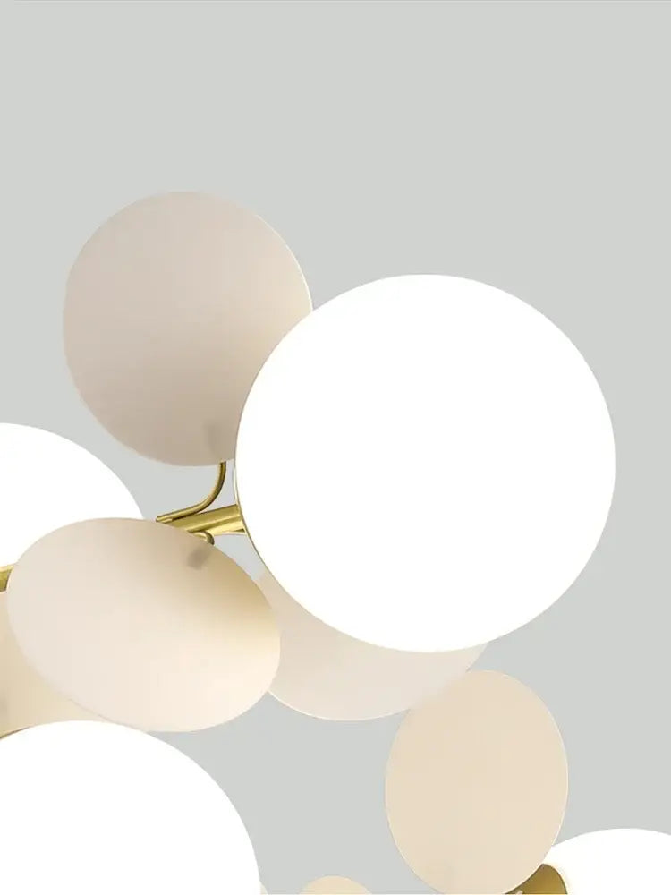 Modern pastel glass hanging ceiling lamp with frosted and opaque white spherical shades on gold decorbites glass hanging frame