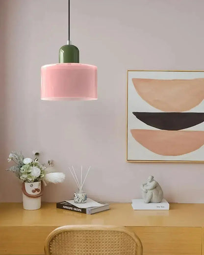 Modern pendant light with a matte pink glass shade and glossy green top for kitchen or dining room use