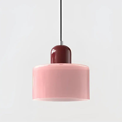 Modern pendant light with soft pink glass shade and glossy burgundy top cap suspended by black cord for kitchen use