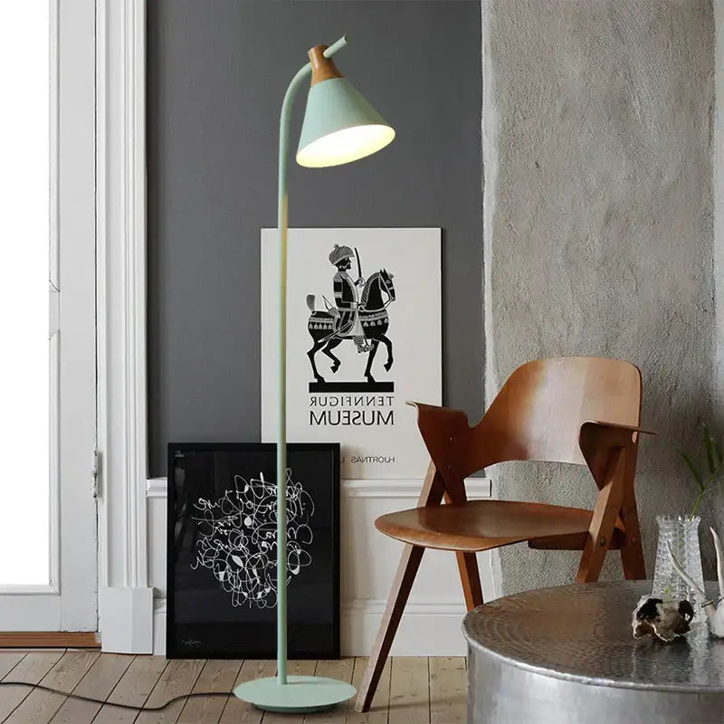 A mint green floor lamp with a curved neck and wooden top from decorbites iron macaron floor lamp collection
