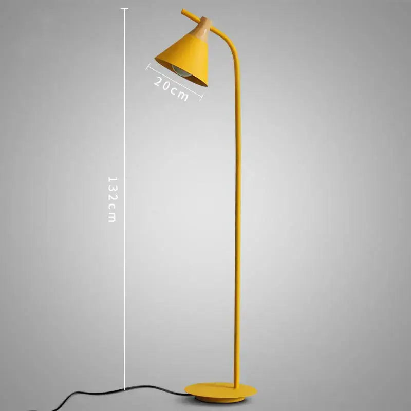 A sleek modern yellow decorbites iron macaron floor lamp with curved metal stand and wood accents for living room decor
