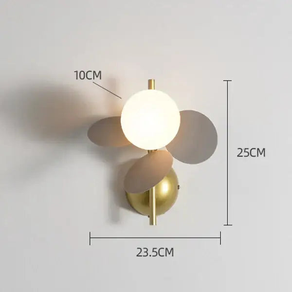 Gold-toned wall lamp with frosted glass globe and matte pastel macaron acrylic petals for children’s bedroom decorbites colorful macaron