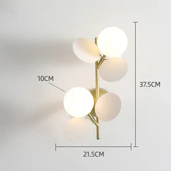 Gold-toned wall lamp with five frosted glass globe shades in branching design for decorbites colorful macaron acrylic decor