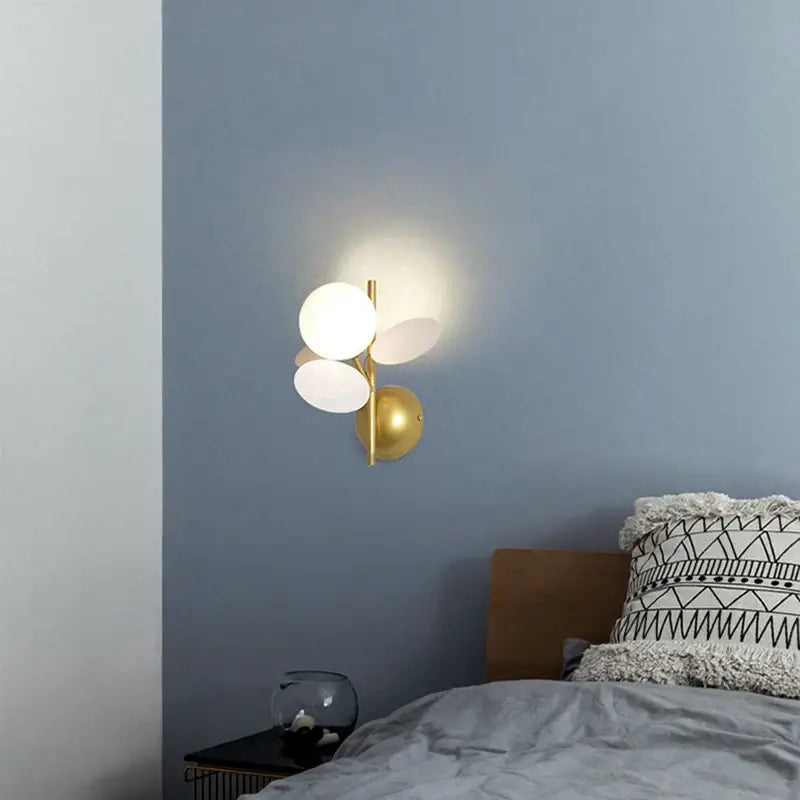 Gold-toned modern wall lamp with three frosted glass orbs featuring macaron acrylic for children’s bedroom decorbites colorful macaron