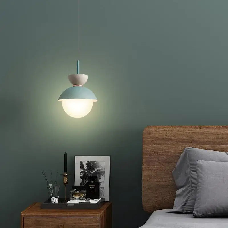 Modern pastel matte ceramic glass ball pendant lamp with teal dome and beige top suspended by black cord decorbites glass ball pendant lamp