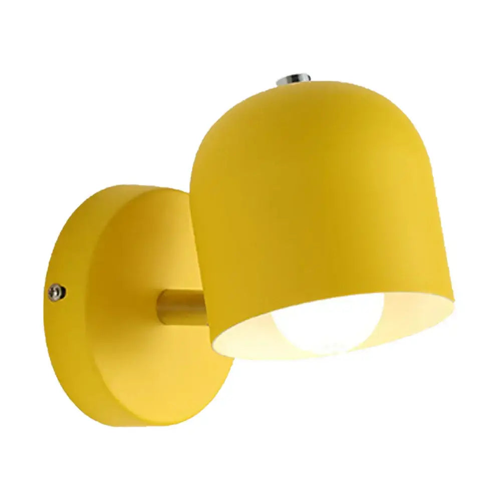 Bright yellow dome-shaped matte iron wall light fixture with metallic mounting hardware for modern bedroom use