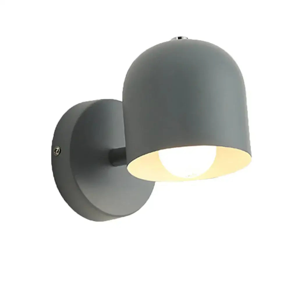 Modern pastel matte iron wall light fixture with a sleek gray dome shade and warm interior lighting for bedroom use