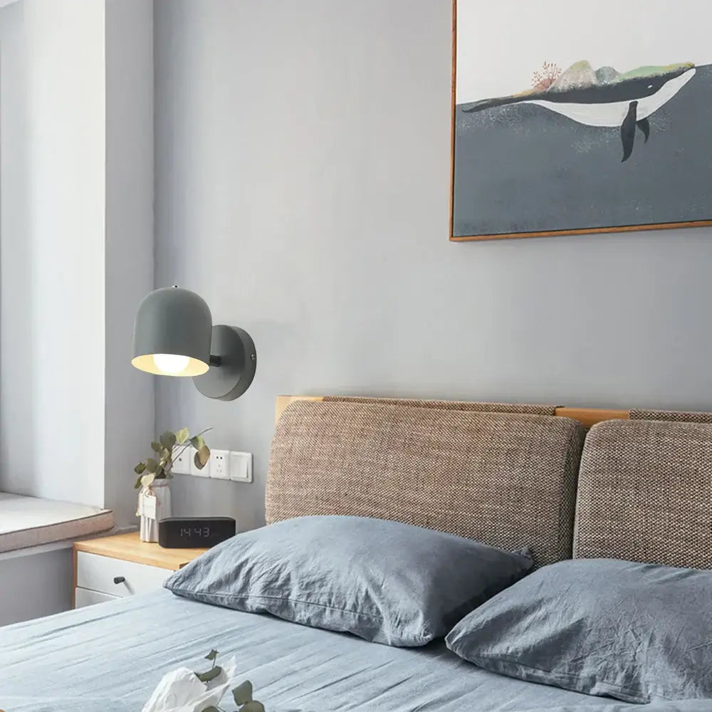 Modern matte gray iron wall light fixture with a rounded dome shade for bedroom wall light installation