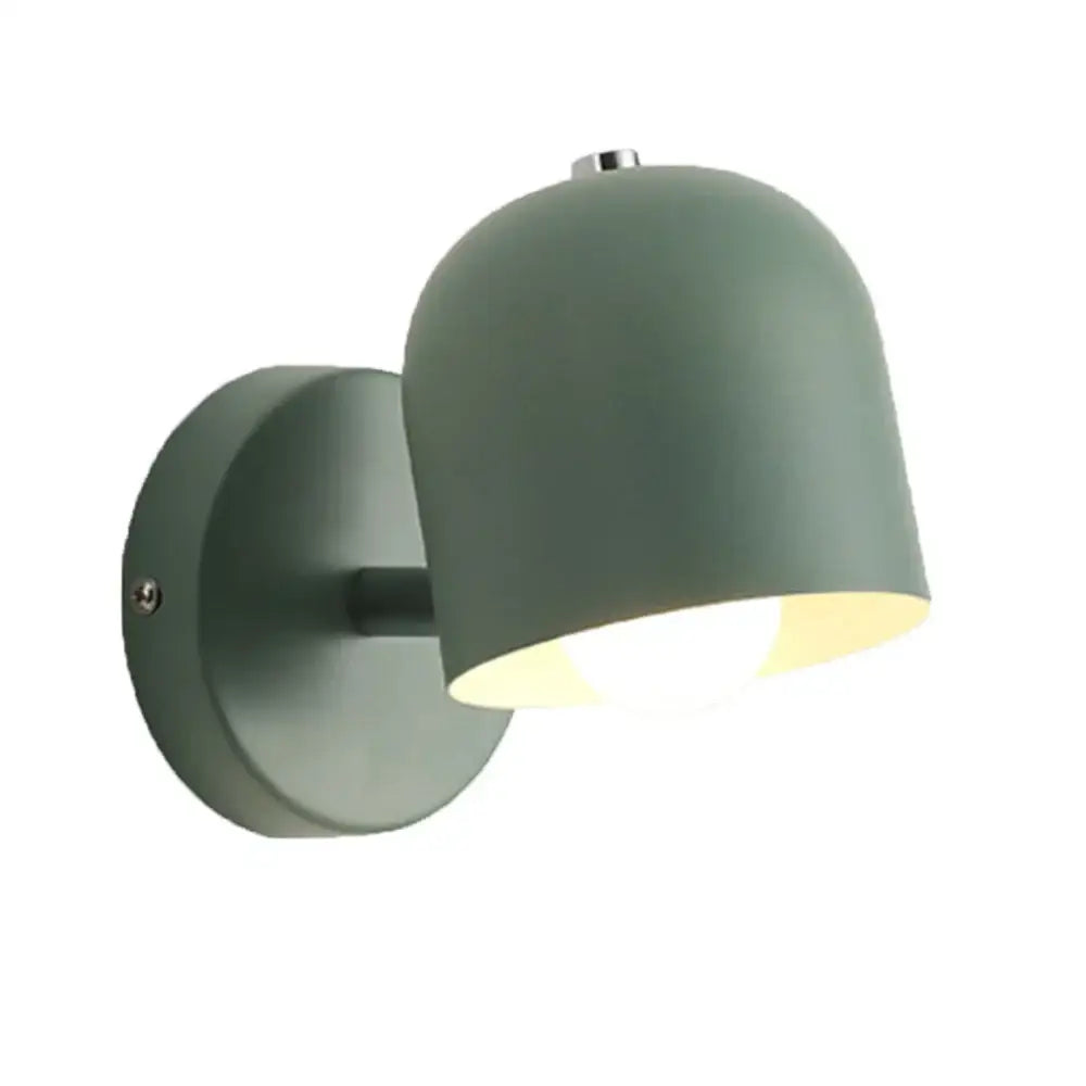Modern pastel matte sage green iron wall light fixture with sleek dome shade and brushed metal bracket for bedroom use