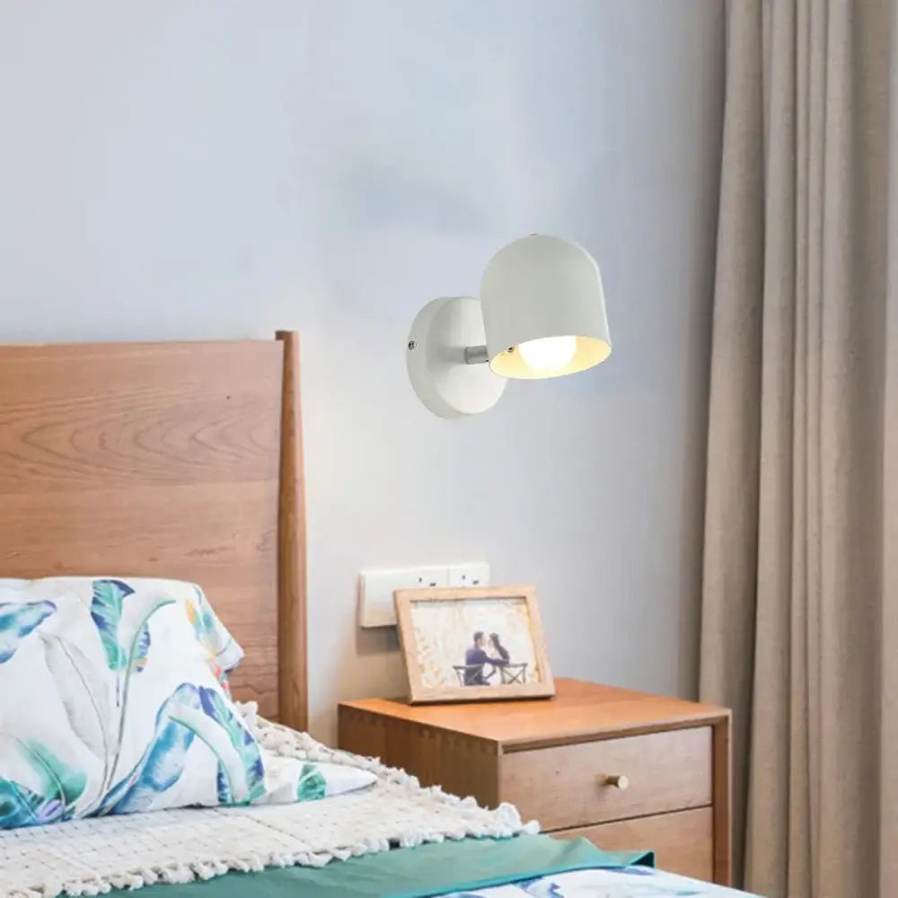 White ceramic wall light fixture with a soft rounded dome shade modern pastel matte iron design for bedroom use