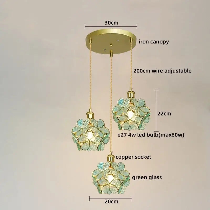 Three-tiered pendant lights with pastel green glass flower-shaped shades and brass decorbites colorful glass led design