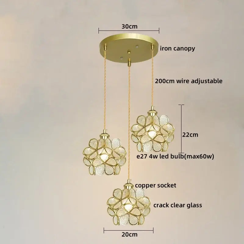 Gold-toned three-light pendant lights with flower-shaped crack clear glass shades and brass frames for dining room decorbites colorful glass led