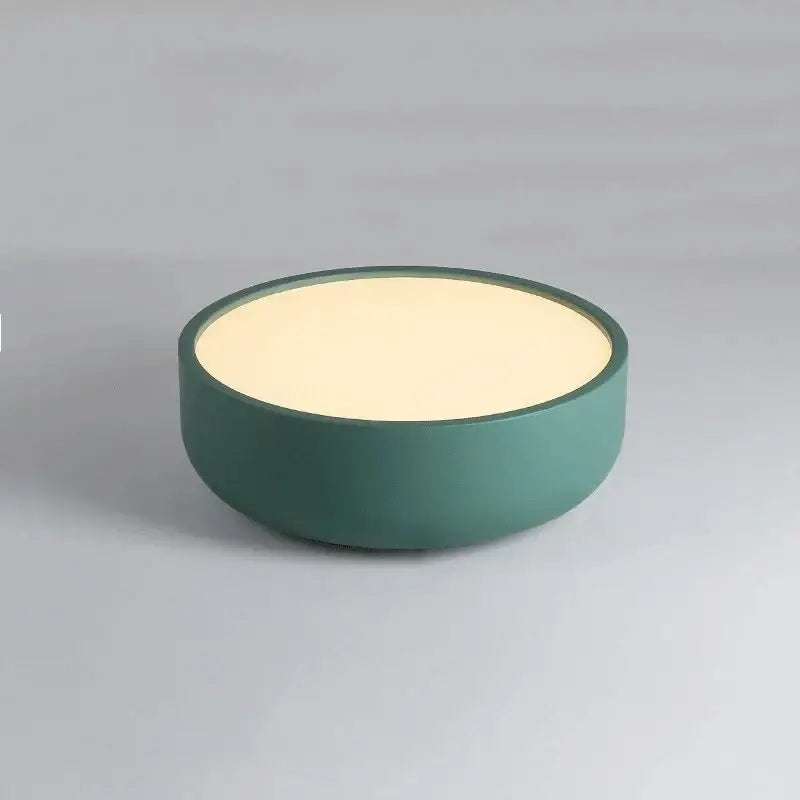 A sleek modern circular led ceiling light with matte teal exterior and warm cream top for bedroom decorbites circular led