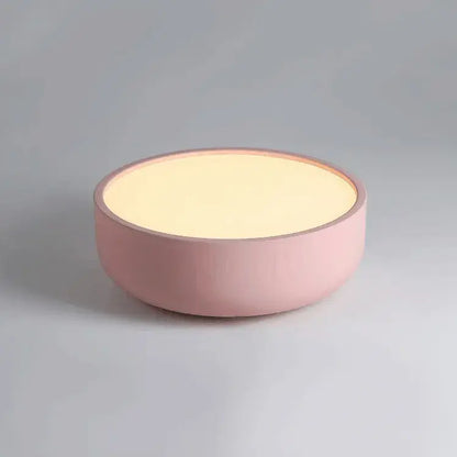 A soft pink round table lamp with matte finish and warm glow complements modern pastel pink and teal decorbites circular led ceiling light