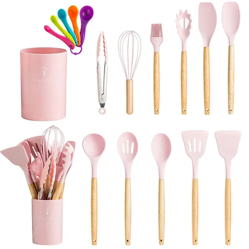 Modern pastel pink silicone kitchen utensil set with wooden handles and matching storage cup for kitchen use