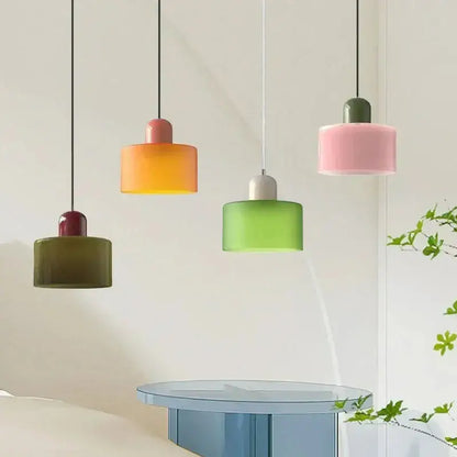 Set of four modern pendant lights with pastel pink orange green and olive stained glass cylindrical shades and cords