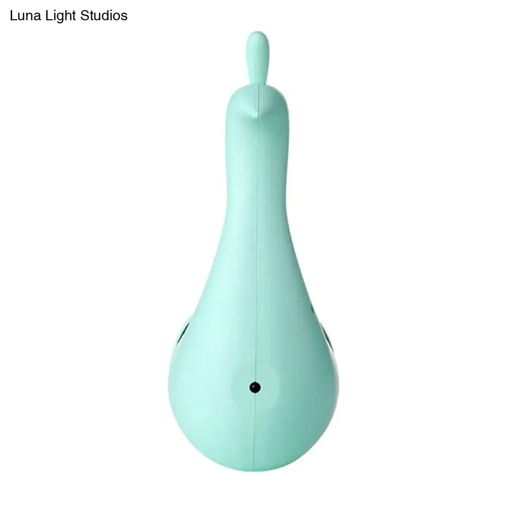 Mint green silicone handheld hair dryer shaped like a stylized bird alongside modern peach peacock wall sconce rainbow light