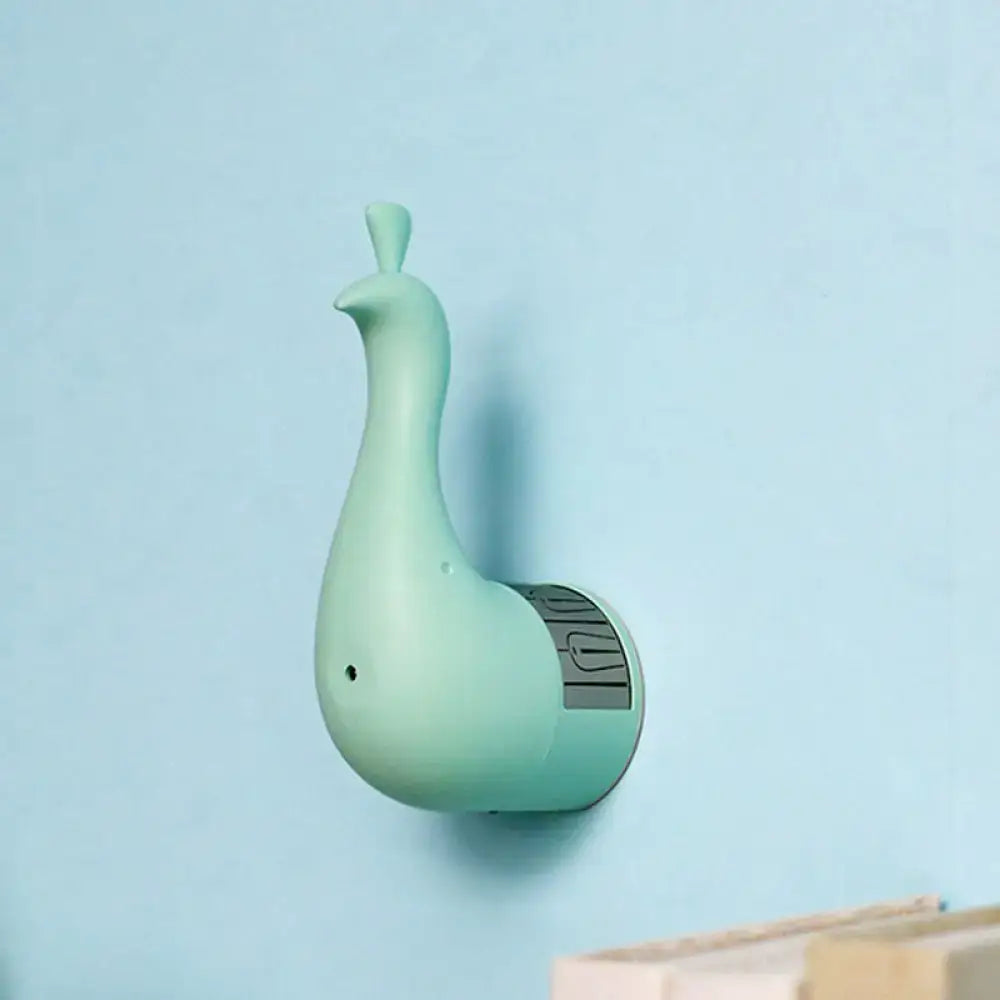 A mint green sleek peacock wall key holder with a circular base for modern bedroom rainbow projection light use