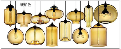 Modern pendant lights featuring amber-tinted glass and black metal fixtures with exposed filament bulbs for bedroom and dining room decor