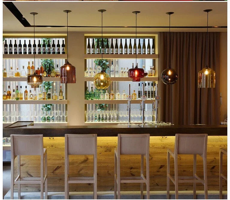 Colorful multicolored glass modern pendant lights hanging above the bar for bedroom dining room or loft decor