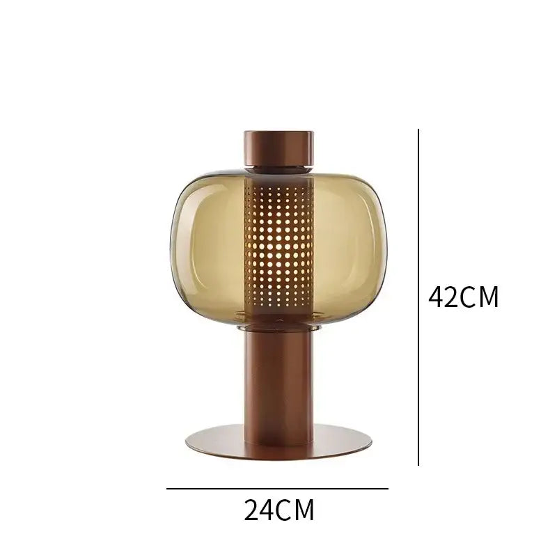 Modern perforated glass table lamp with translucent amber body and bronze base for bedroom and living room decorbites glass table