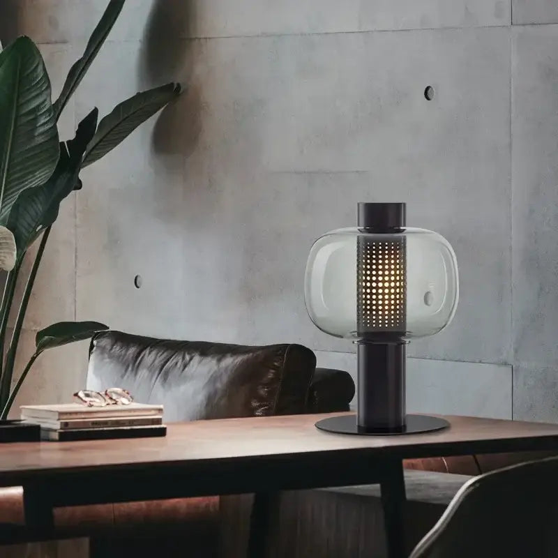 Modern perforated glass table lamp with clear globe, black metal base, and illuminated column for bedroom decorbites glass table lamp