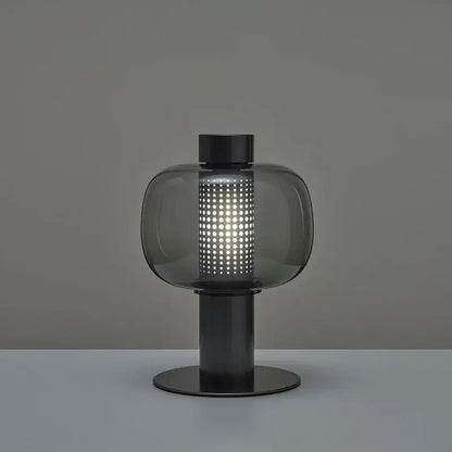 Modern perforated glass table lamp with dark gray smoked shade and black metal base ideal for bedroom and living room decorbites decor