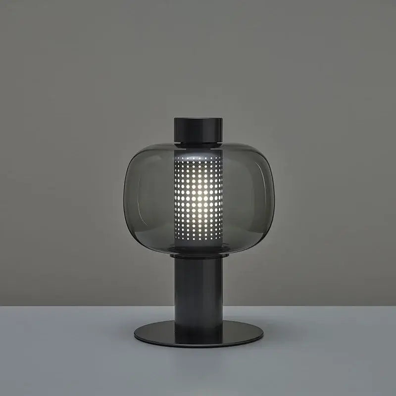 Modern perforated glass table lamp with dark gray smoked shade and black metal base ideal for bedroom and living room decorbites decor