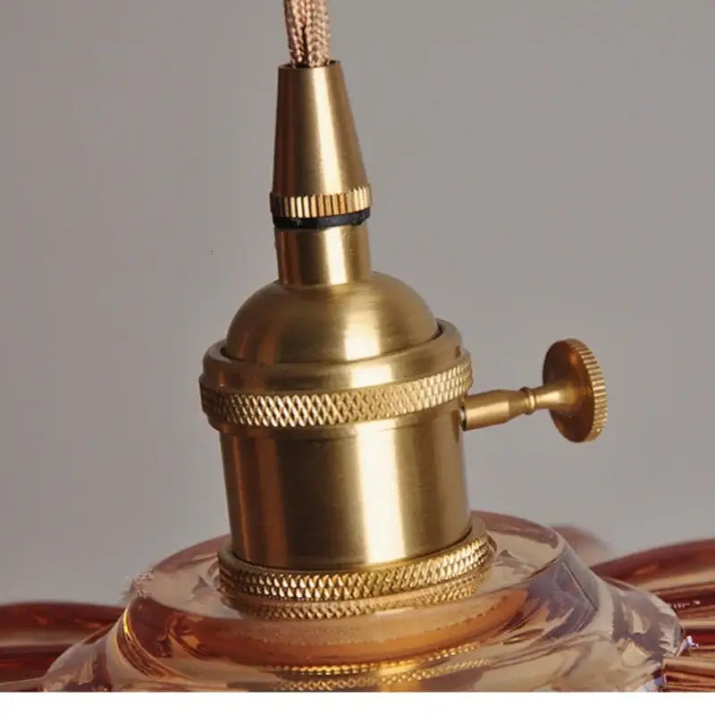 Brass-finished vintage-style light fixture socket with textured ridged bands and knurled knob for amber glass led pendant lamp