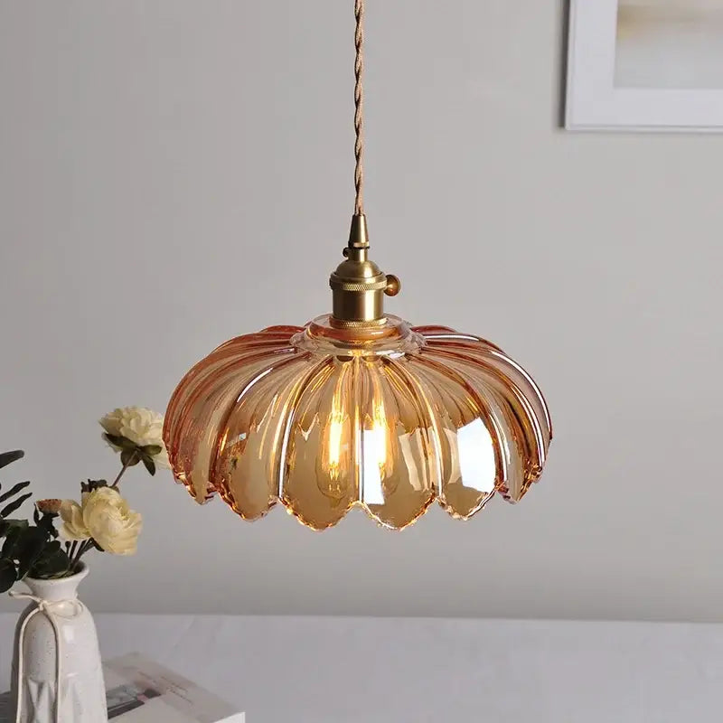 Amber-colored glass led pendant lamp with fluted petal design and brass hardware for dining room lighting