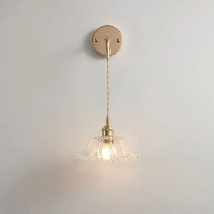 Modern petal clear glass led wall light with brass finish, decorbites clear glass shade, and twisted cord for bedroom use