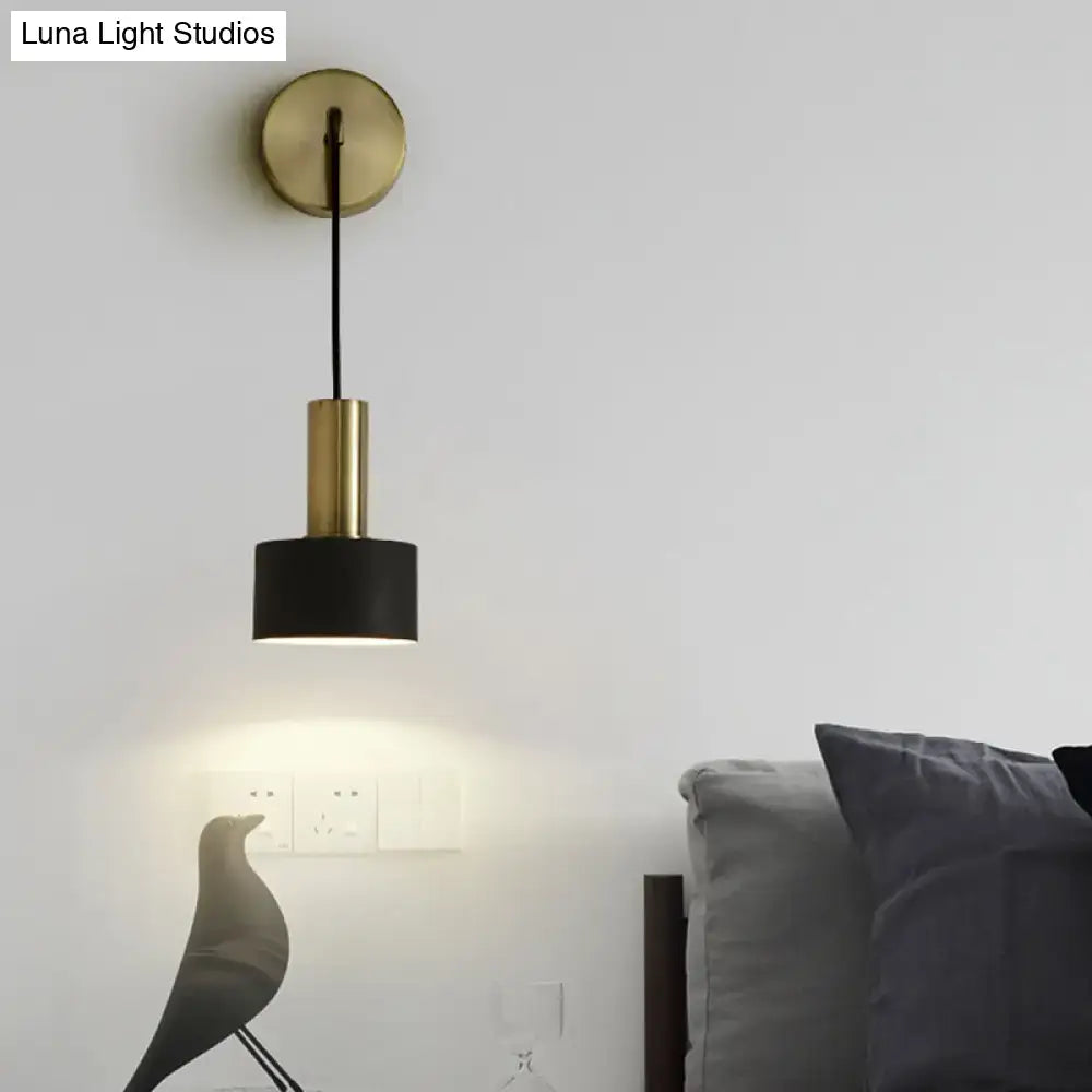 A modern brass and black cylindrical pendant bedside reading light with e14 e26 e27 bulb compatibility and circular mount