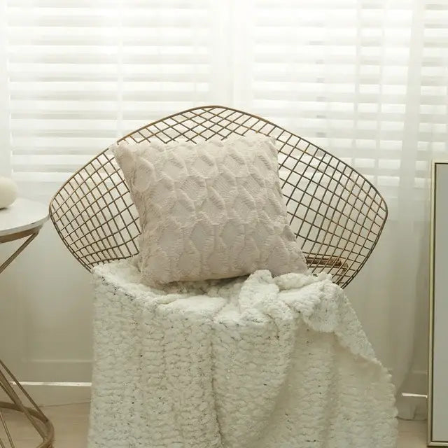 Cream-colored textured knit cushion cover on wireframe chair complements modern pink and beige diamond embroidery cushion