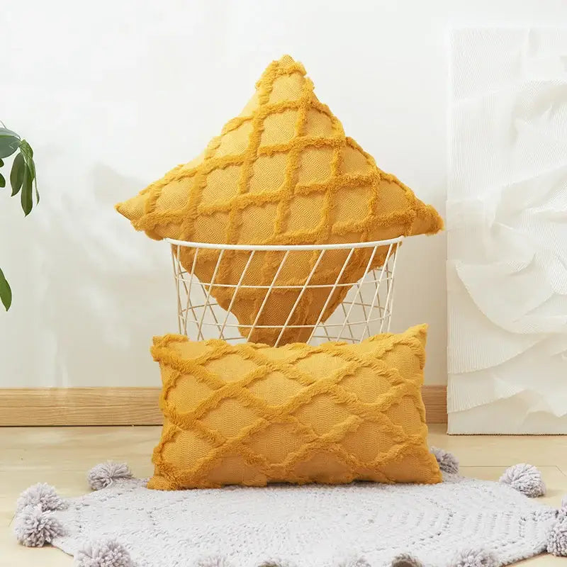 A mustard-yellow diamond embroidery cushion cover with textured weave and frayed edges shown in two shapes