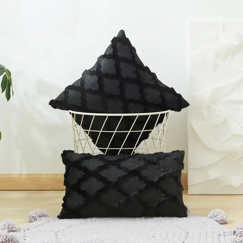 Black textured throw pillows with diamond embroidery cushion cover and frayed edges displayed in wire basket