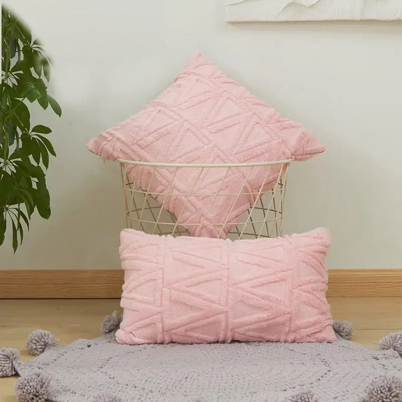 Soft pink textured throw pillows with geometric diamond embroidery cushion cover and tassel trim for living room