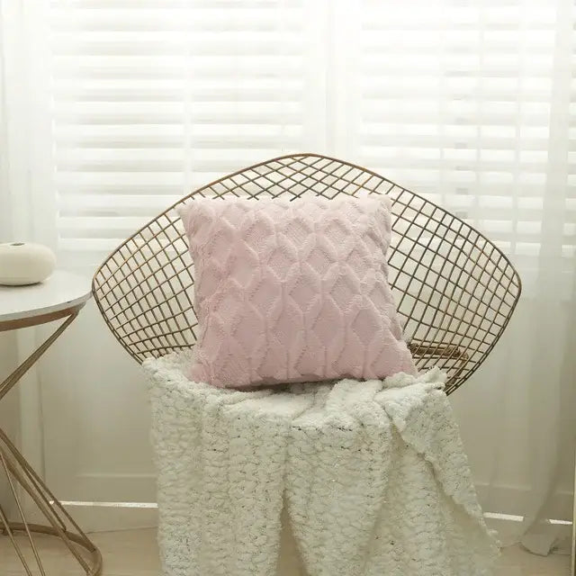 A soft pink diamond embroidery cushion cover with textured knit pattern on a wire-frame chair for living room use
