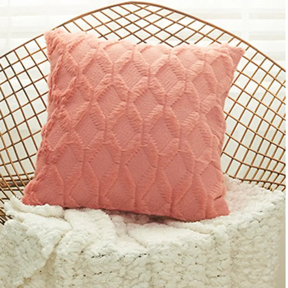 A soft blush pink cushion cover with textured diamond embroidery and plush fabric for living room decor