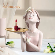 Pastel pink butterfly girl resin figure holding a gold tray with white and peach butterflies for living room decor