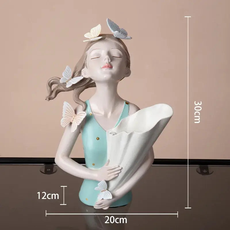 Porcelain butterfly girl sculpture holding a white fan with delicate cream and gray butterflies for living room decor