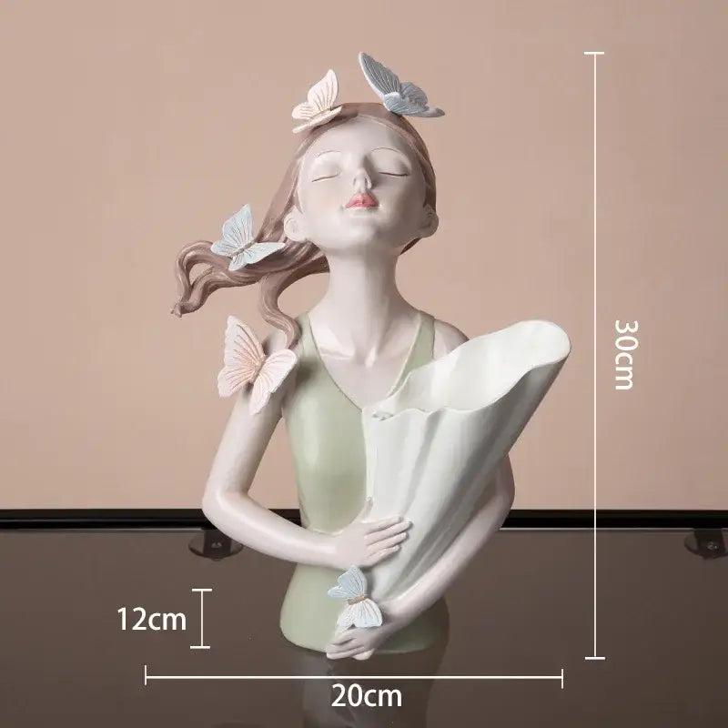 Delicate modern pink butterfly girl sculpture in resin featuring pastel butterflies holding a white scroll decorbites butterfly girl