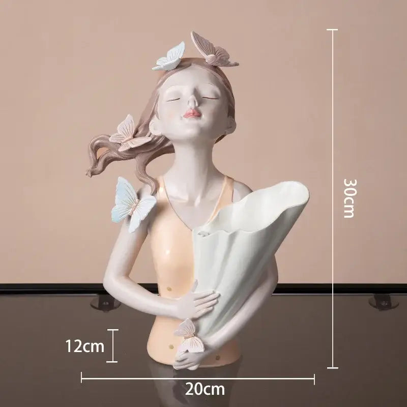 Delicate resin butterfly girl sculpture holding a bouquet in peach and white tones for modern living room decorbites decor