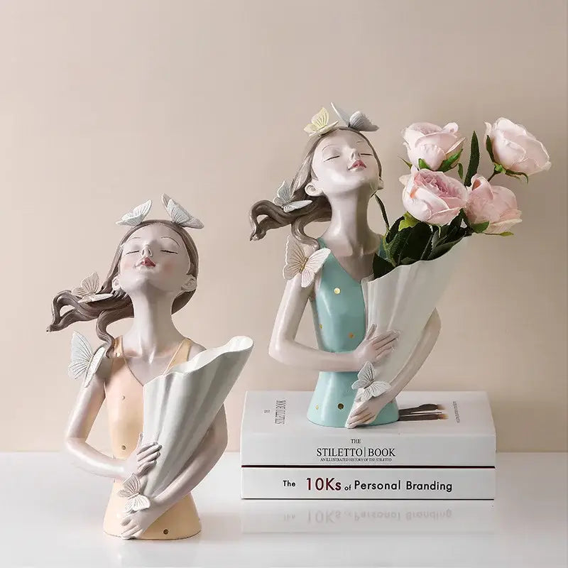 Two ceramic butterfly girl sculptures in peach and mint green with resin flower vase for modern living room decorbites decor