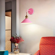 Modern pink conical metal wall sconce with brass-finished mounting plate ideal for gray pink hallway lighting