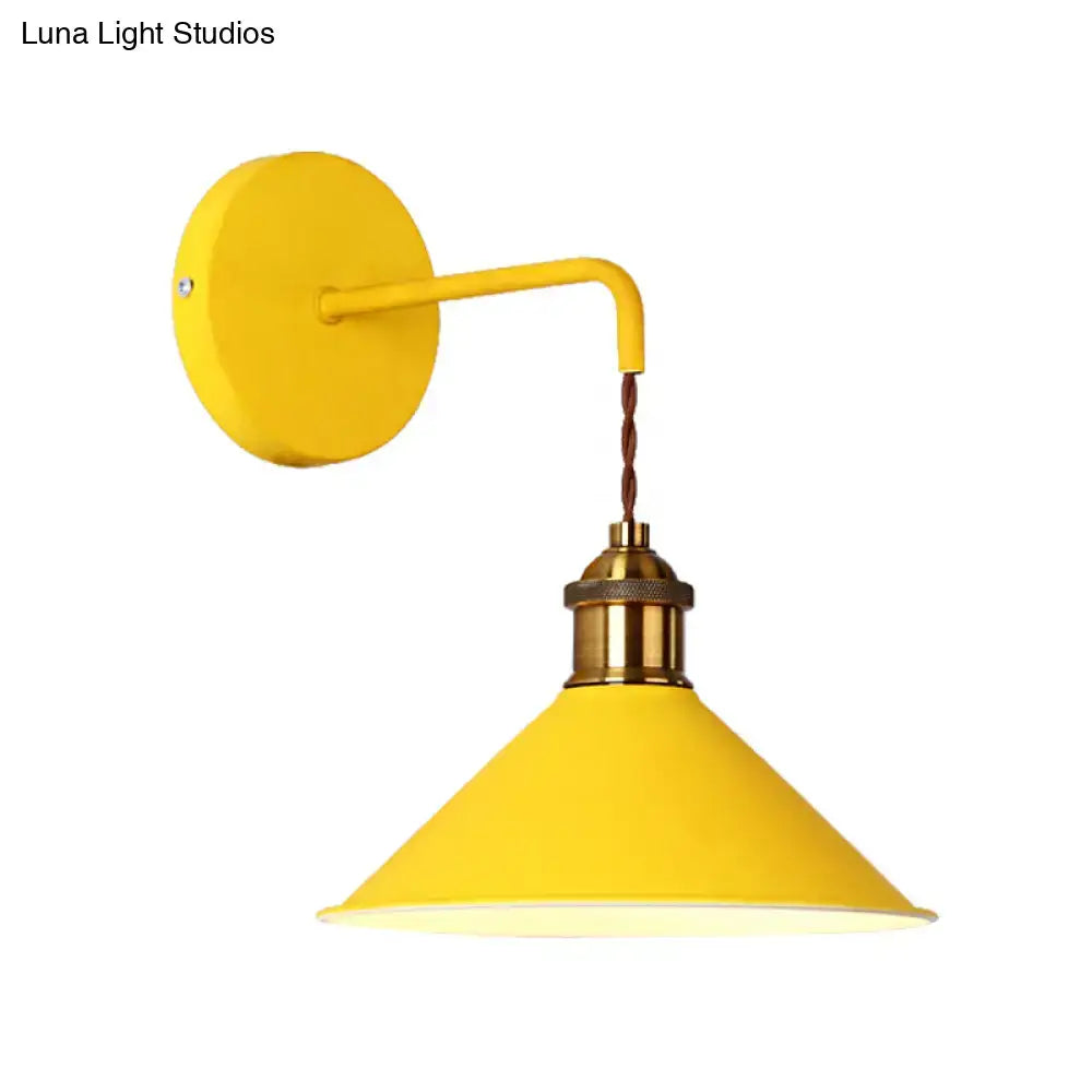 Modern pink conical metal wall sconce with bright yellow industrial style and brass base for gray pink yellow decor
