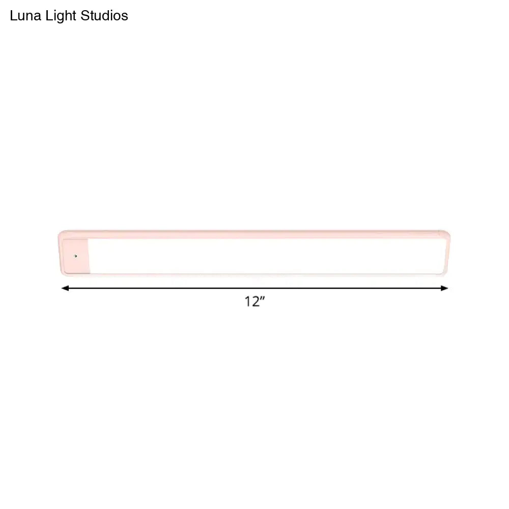 A sleek 12-inch plastic elongated vanity lighting fixture with soft pink casing and bright white panel for bedroom use