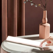 Modern pink elongated vanity lighting fixture with a sleek plastic elongated vanity led light bar for bedroom use