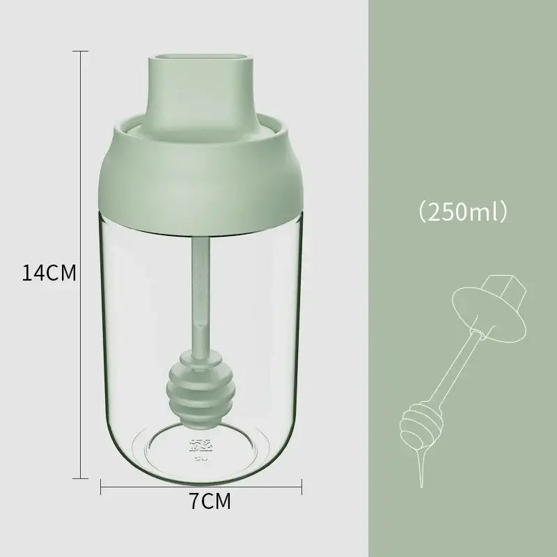 A clear glass seasoning bottle with sage green lid and dipper designed for 250ml in a modern pink glass seasoning bottle set
