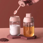 Modern pink glass seasoning bottle set with silicone lids and integrated spoons for sugar and honey storage