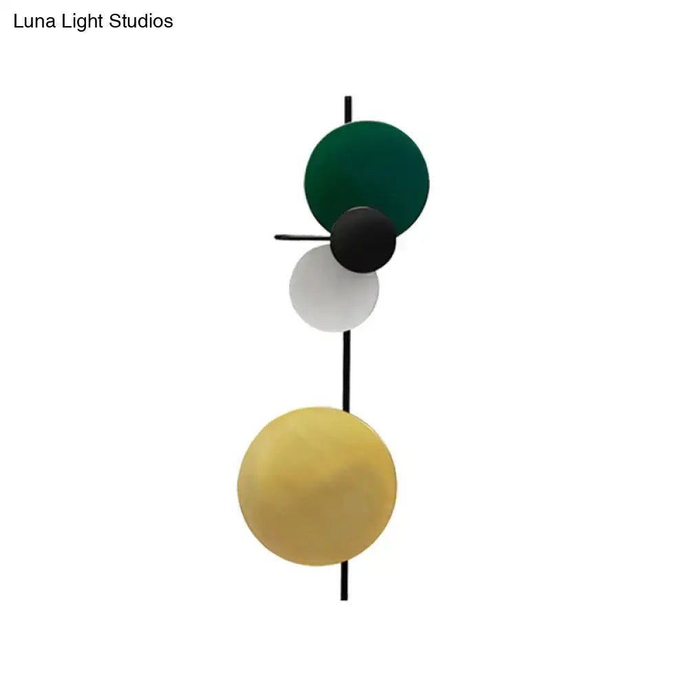 Modern geometric wall light with stacked circular shades in deep green white yellow matte black and mustard yellow